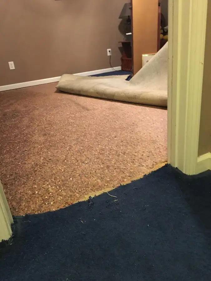 Carpet pad removal revealing water damage during Water Mitigation Services in Fort Bragg